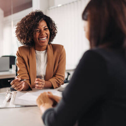 Female financial advisor consulting a client at the meeting and having business conversation or making offer